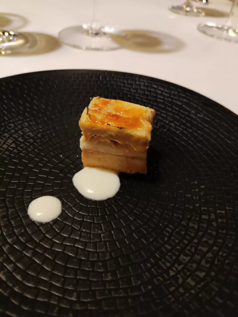 Milhojas caramelizado de anguila ahumada, foie gras, cebolleta y manzana verde